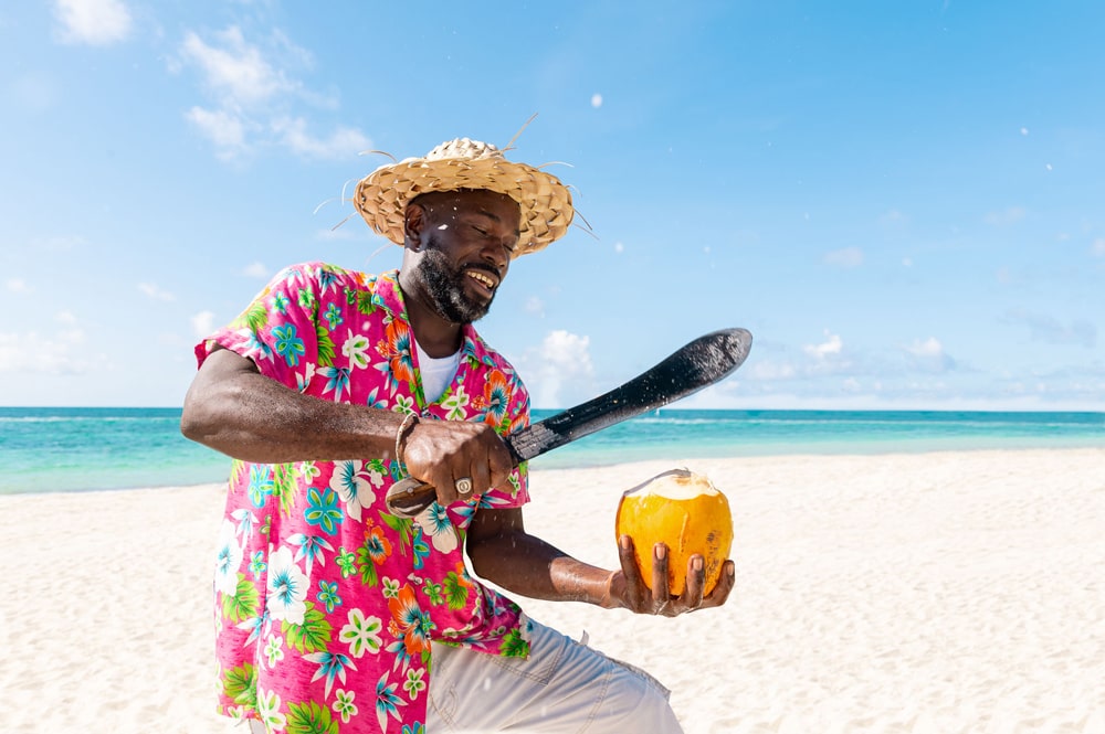 A local chopping coconut on the beach